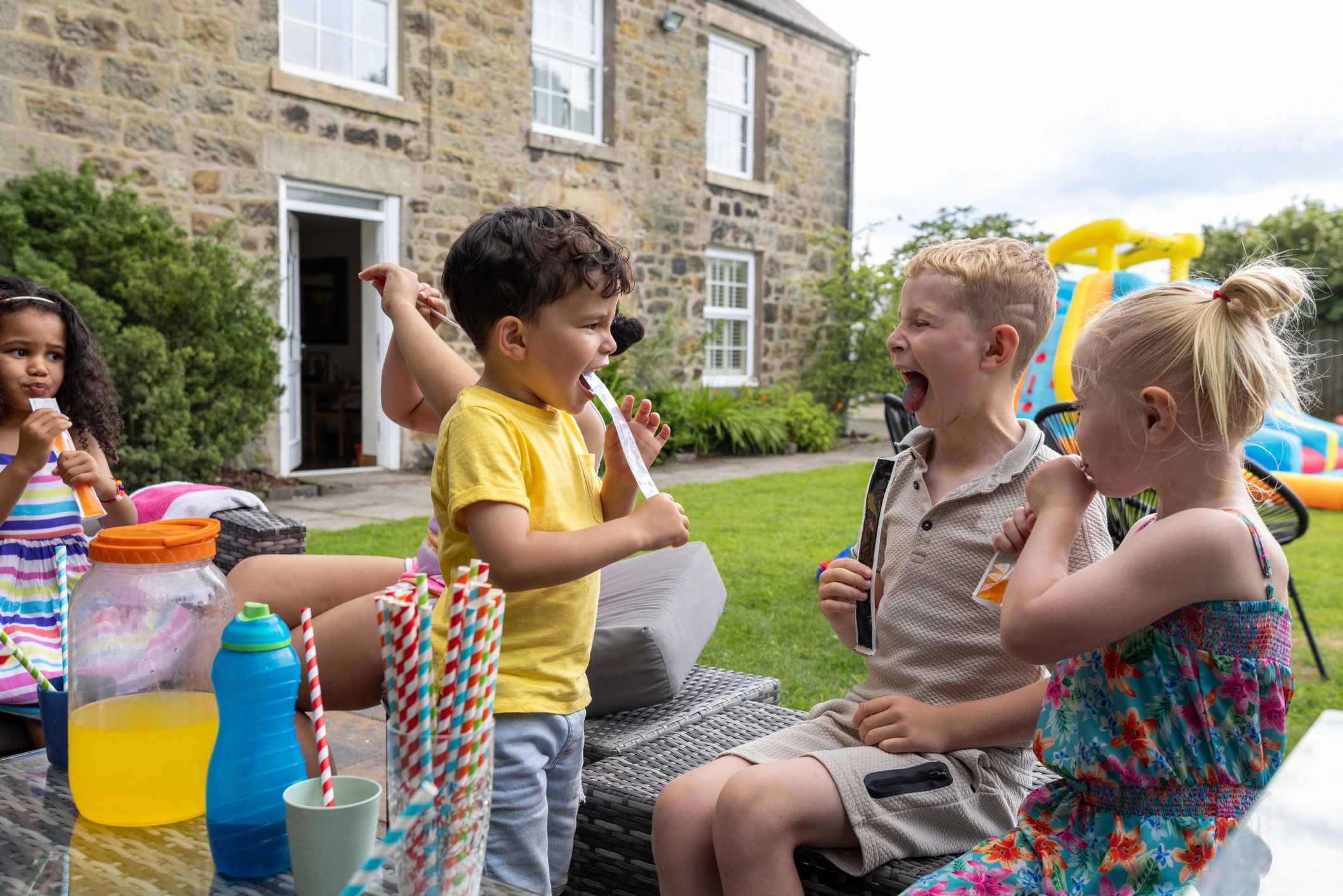 Children enjoying a colorful outdoor party setup