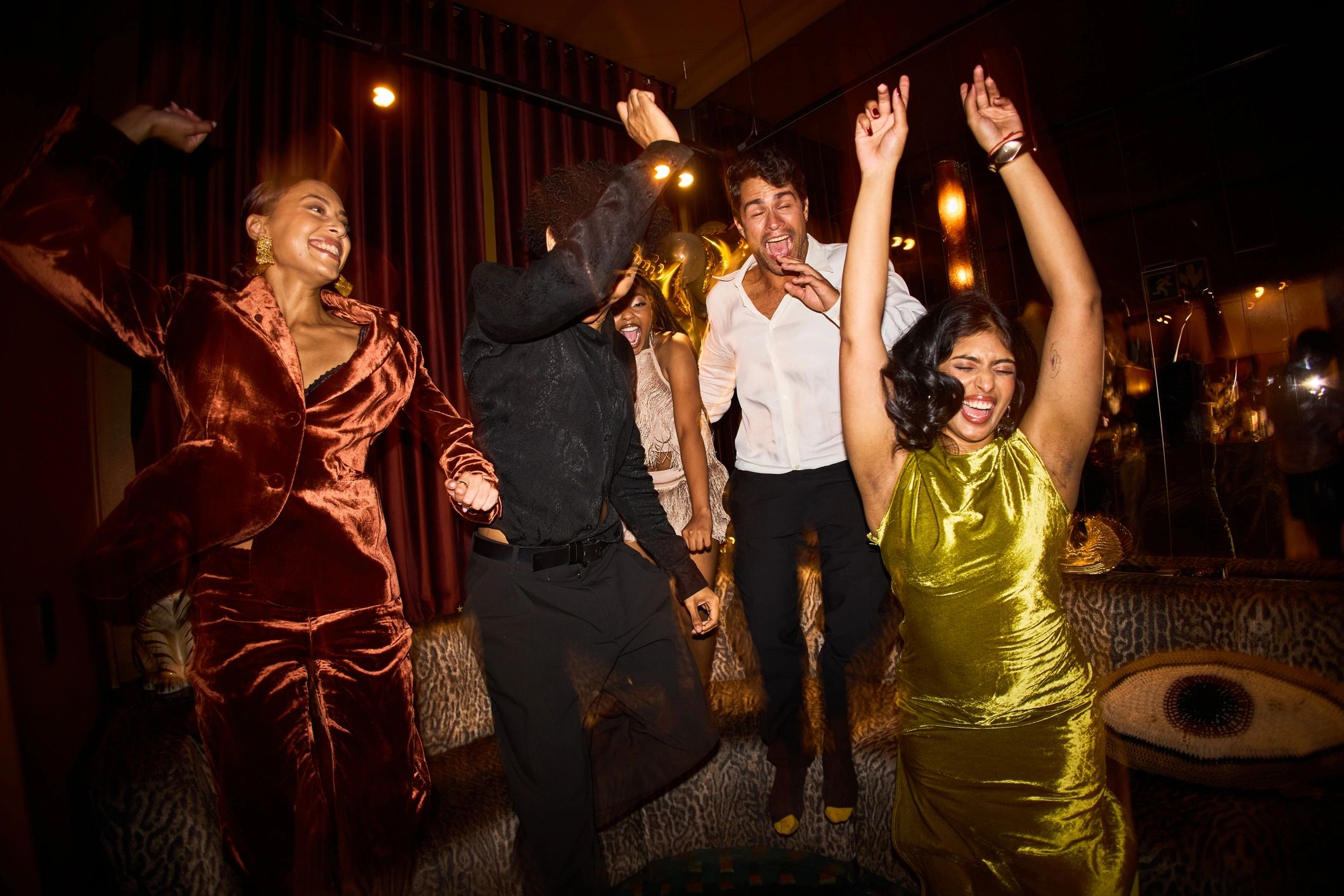 Friends celebrating on a dance floor with party music